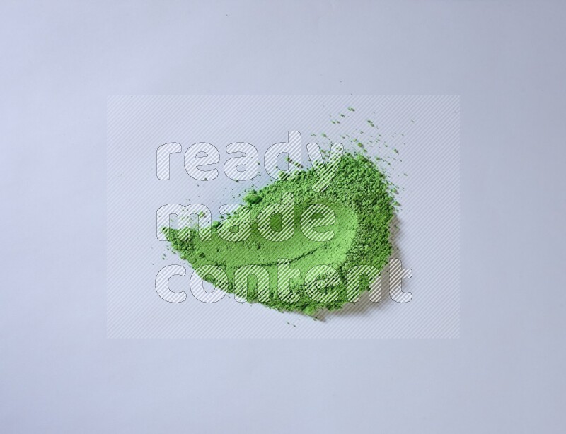 Green powder smears on white background