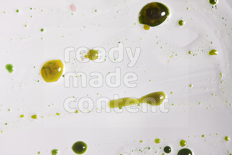 Close-ups of abstract yellow and green paint droplets on the surface