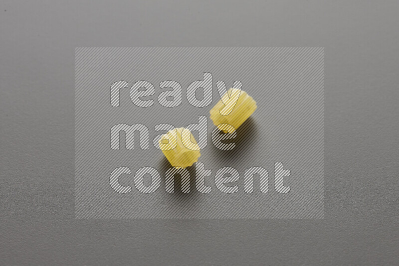 Small rings pasta on grey background