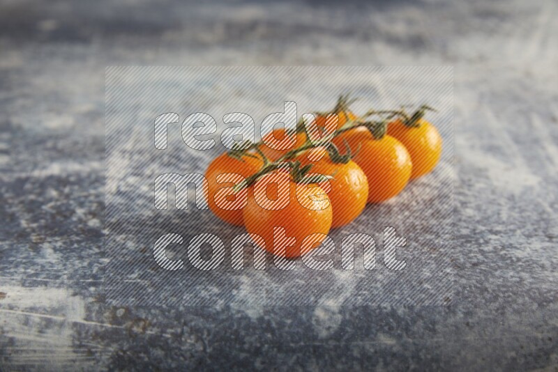 Orange cherry tomato vein on a textured rusty blue background 45 degree