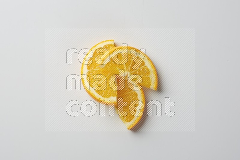 Three halves of an orange slices on white background
