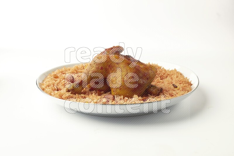 red basmati Rice with  kabsa chicken pieces on a white plate with a silver rim direct  on white background
