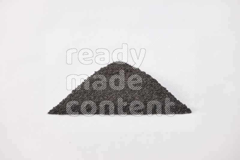 Black seeds in a triangle shape on a white flooring