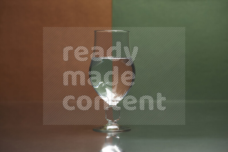 The image features a clear glassware filled with water, set against brown and dark green background