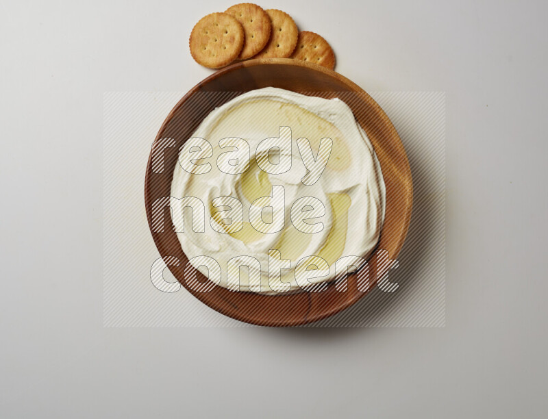 Lebnah garnished with olive oil in a wooden plate on a white background