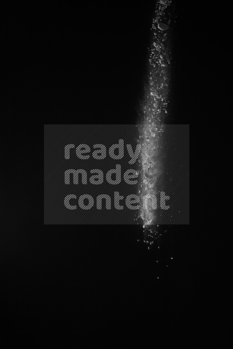 A side view of white powder explosion on black background
