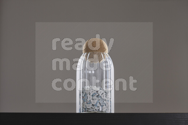 Buttons in a glass jar on black background