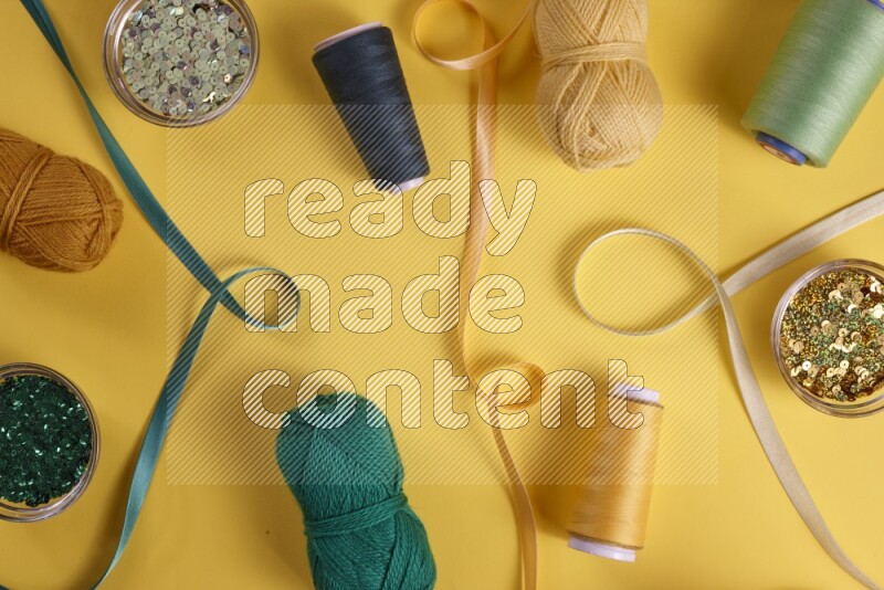 A green collection of sewing and tailoring tools arranged on a yellow background