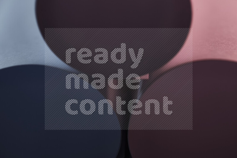 The image shows an abstract paper art with circular shapes in varying shades of blue and red