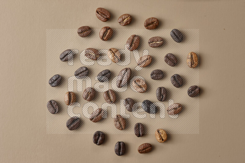 Roasted coffee beans on beige background