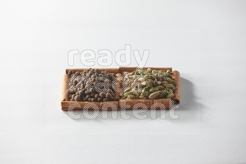 2 squares of cinnamon sticks full of cardamom and allspice on white flooring
