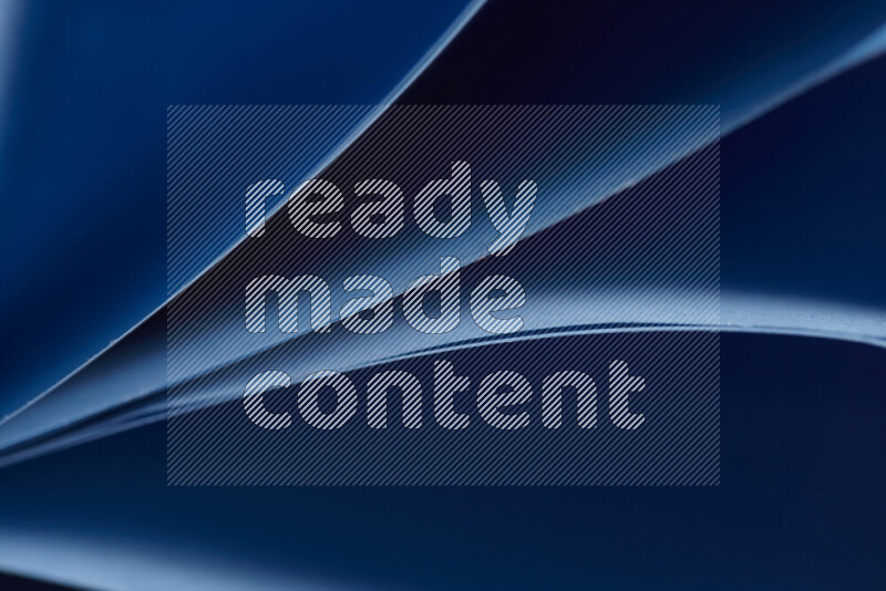 An abstract art showing blue paper sheets arranged in an overlapping curves