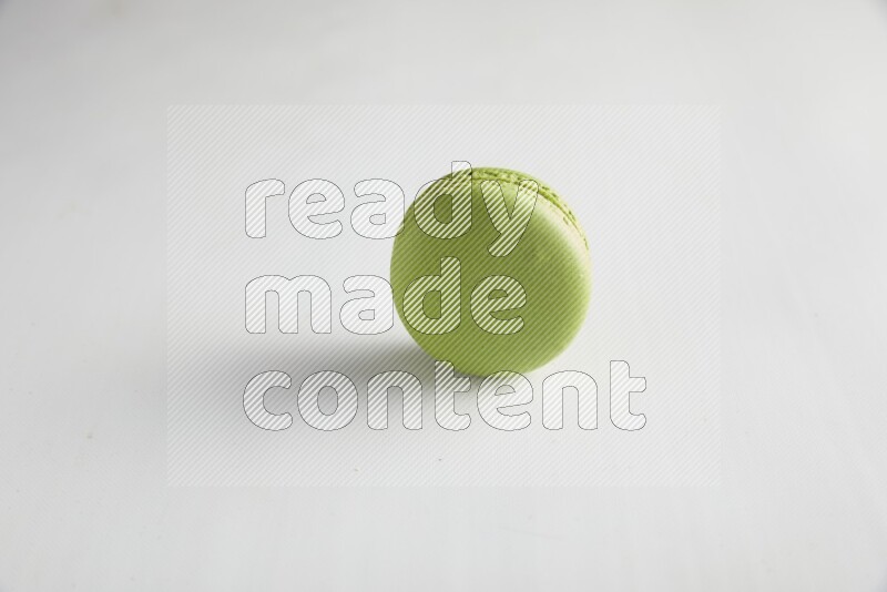 45º Shot of Green Pistachio macaron on white background