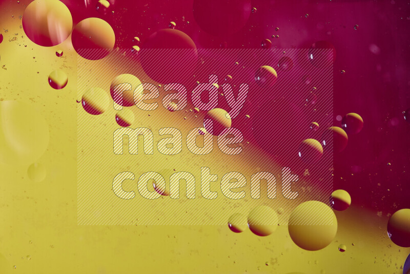 Close-ups of abstract oil bubbles on water surface in shades of red and yellow