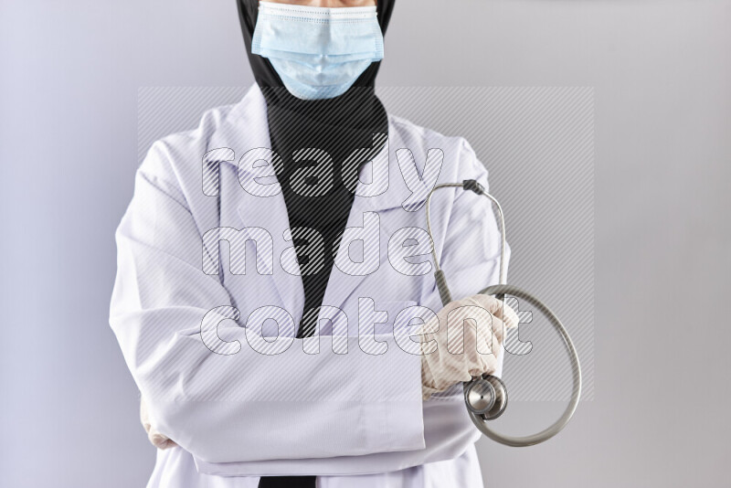 Female doctor wearing an abaya and medical attire in different positions