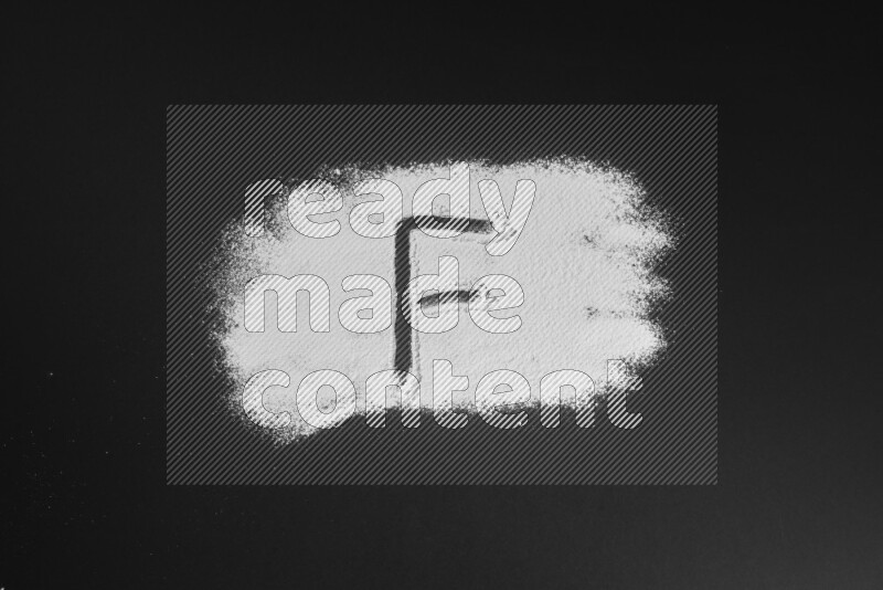 Alphabets written with powder on black background