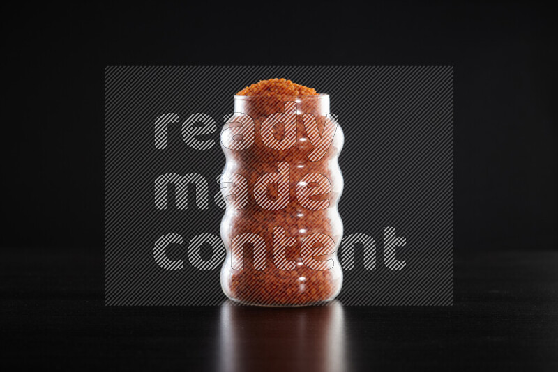 Lentils in a glass jar on black background