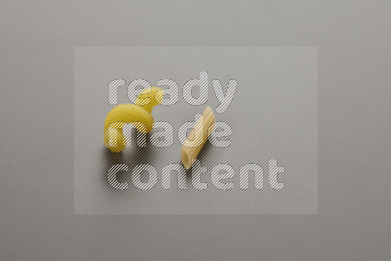 Twist pasta with other types of pasta on grey background