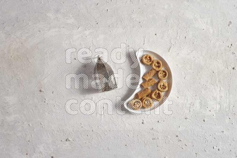 Oriental sweets in a pottery plate with lantern in a light setup