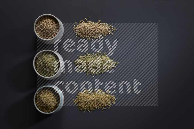 Legumes in pottery bowls on grey background