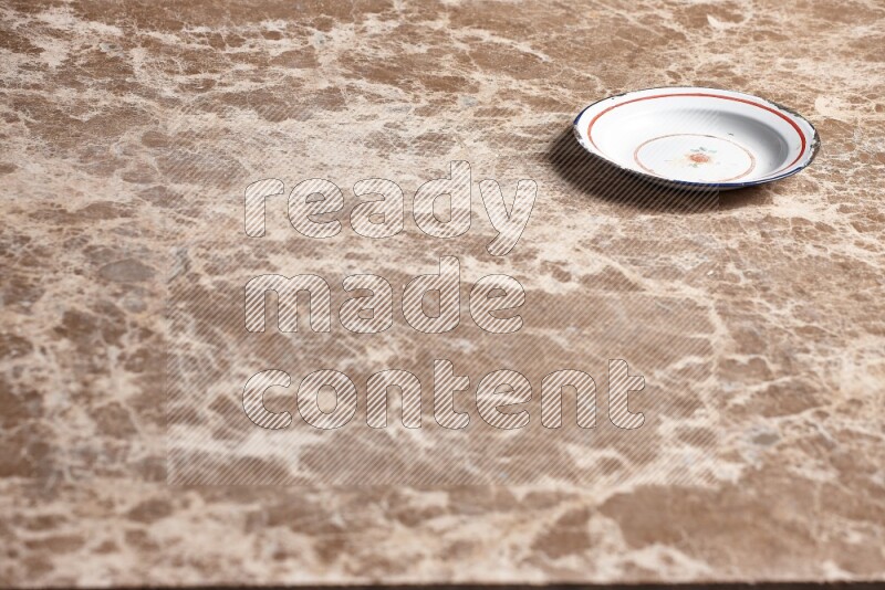 A vintage metal plate on beige marble background