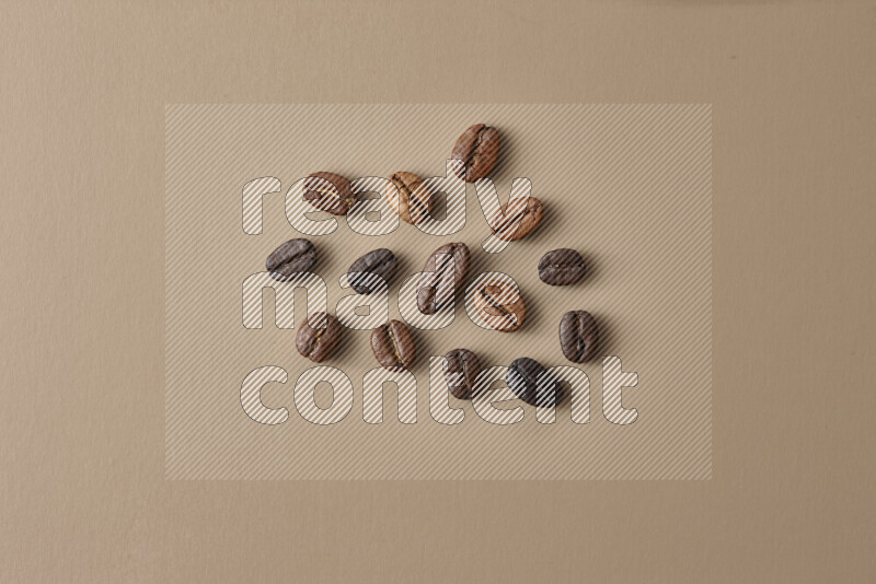 Roasted coffee beans on beige background