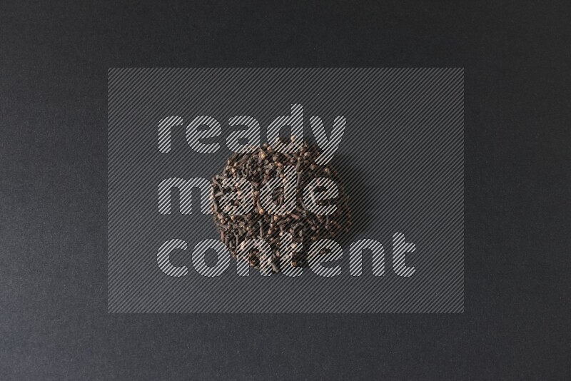 Cloves in a circle shape on a black flooring