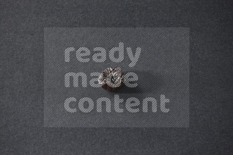 A dried plum on a black background in different angles