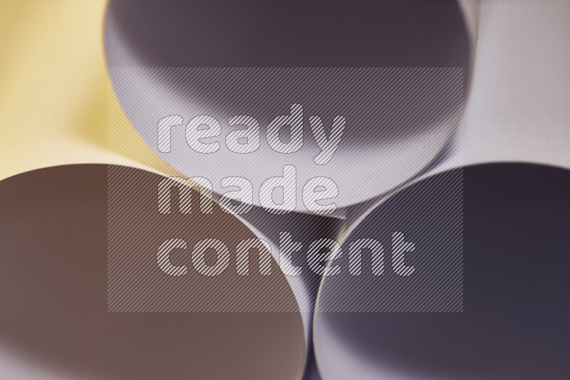 The image shows an abstract paper art with circular shapes in varying shades of grey and warm tones