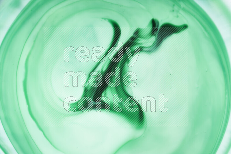 A close-up of abstract swirling patterns in green gradients