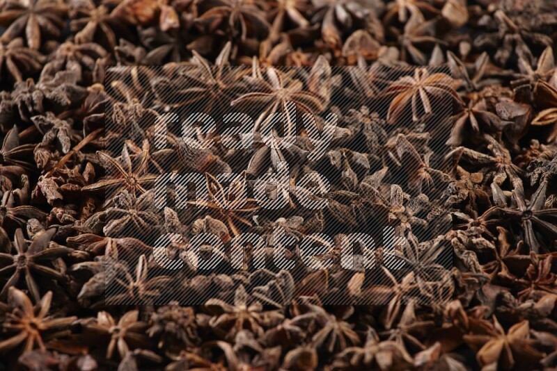 Star Anise herbs fill the frame on black flooring