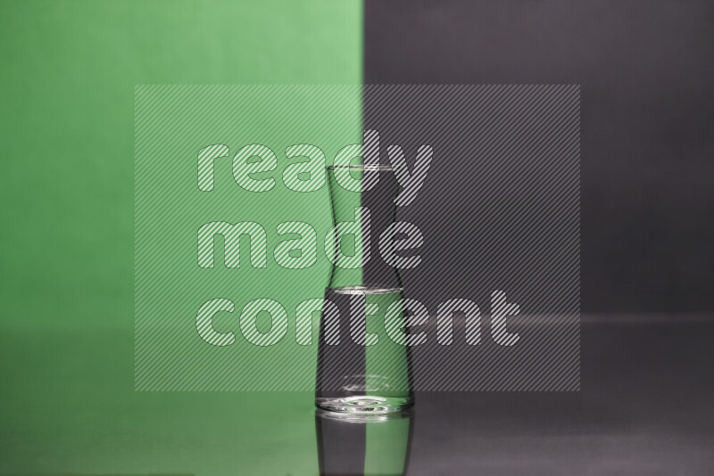 The image features a clear glassware filled with water, set against green and black background