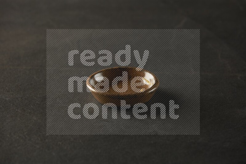 multi color round sauce bowl on grey textured countertop