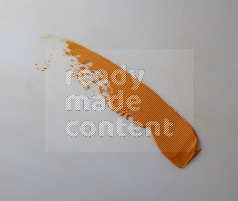 An orange straight painting knife stroke on white background