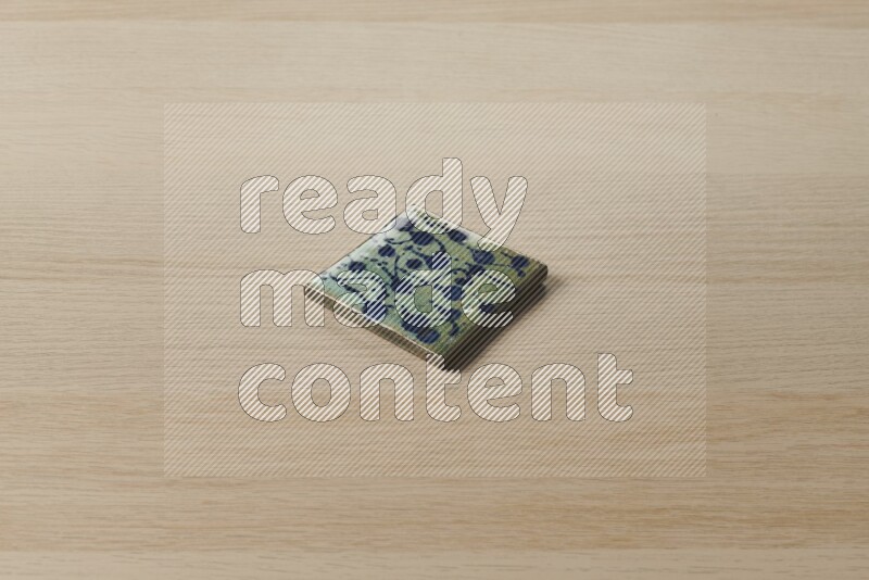 A decorative coaster on light wooden background