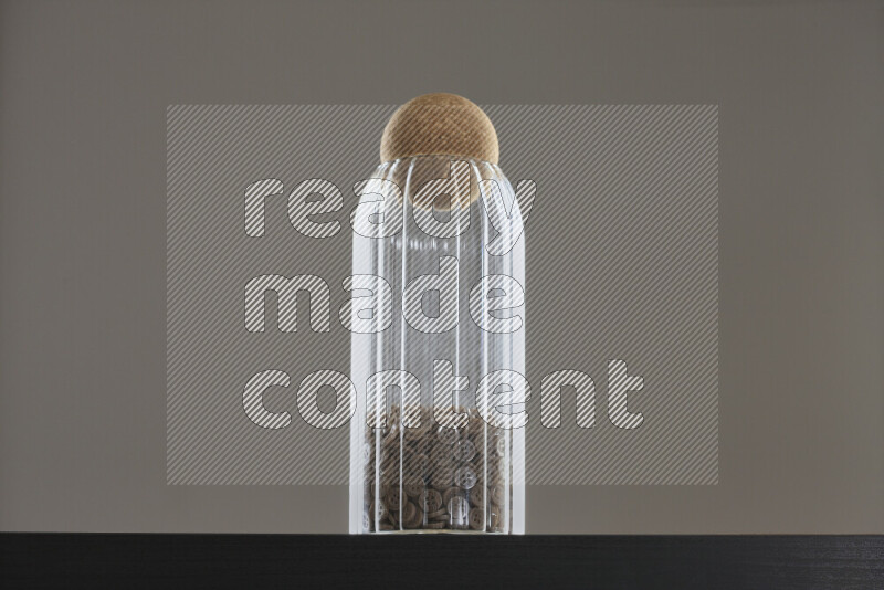 Buttons in a glass jar on black background