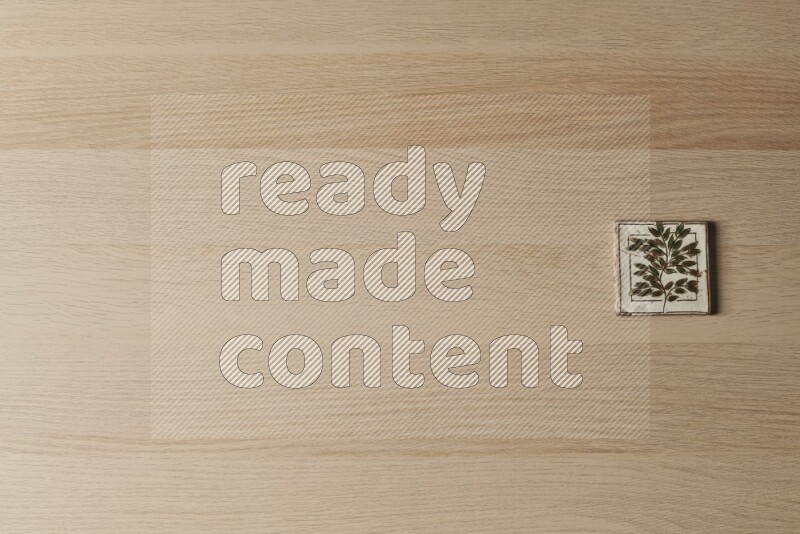A decorative pottery coaster on light wooden background
