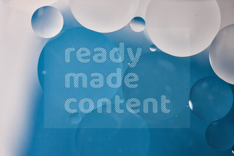 Close-ups of abstract oil bubbles on water surface in shades of white and blue