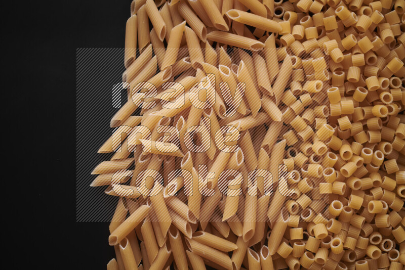Different pasta types on black background