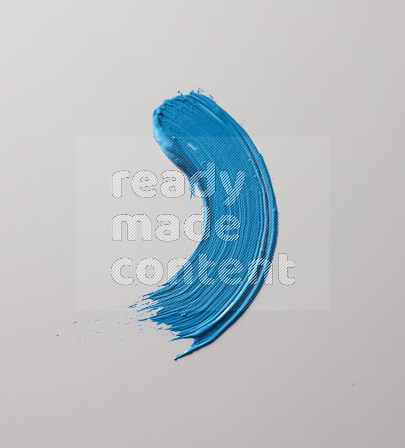 A single blue curved brush stroke on a white background