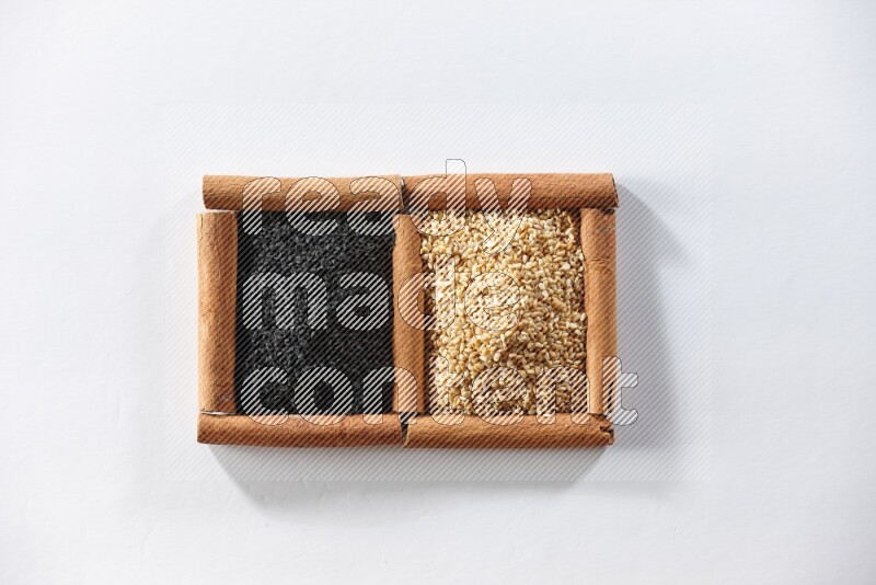 2 squares of cinnamon sticks full of sesame and black seeds on white flooring