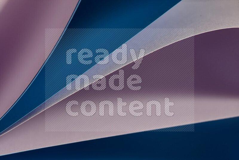 An abstract art showing purple and blue paper sheets arranged in an overlapping curves
