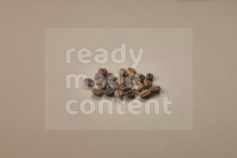 Roasted coffee beans on beige background