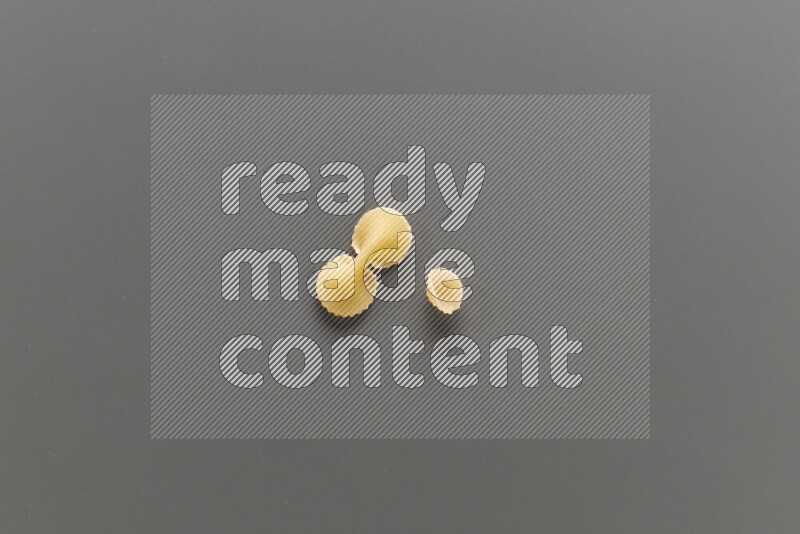 Fiocchi pasta with other types of pasta on grey background