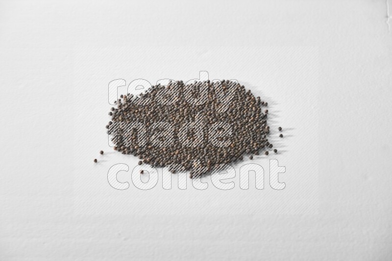 Black pepper on a white flooring