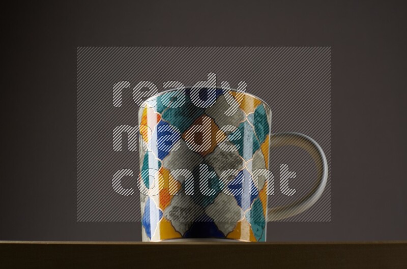 Low angle shot of a decorated cup on grey background