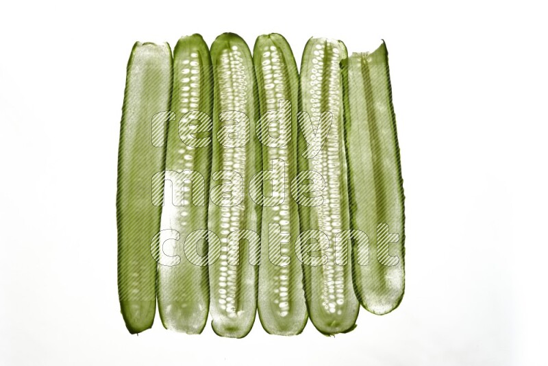 Cucumber slices on illuminated white background