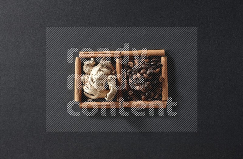 2 squares of cinnamon sticks full of coffee beans and ginger on black flooring