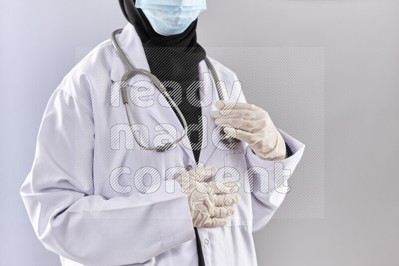 Female doctor wearing an abaya and medical attire in different positions