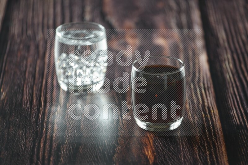 Cold drinks in a glass cup such as water, tamarind, qamar eldin, sobia, milk and hibiscus on wooden background